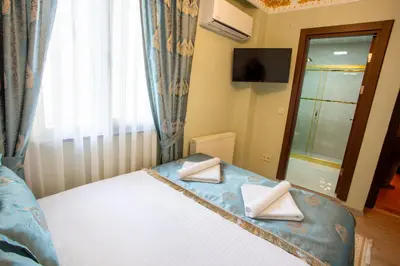 a bedroom with a bed with two towels on it at Sayina Hotel in Istanbul