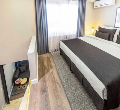 a bedroom with a large bed and a window at APARTMENTS BAKRAC 26 in Istanbul