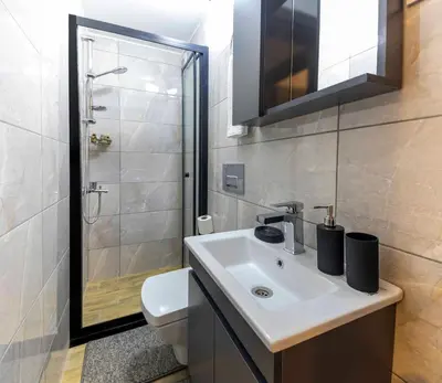 a bathroom with a sink and a shower and a toilet at APARTMENTS BAKRAC 26 in Istanbul