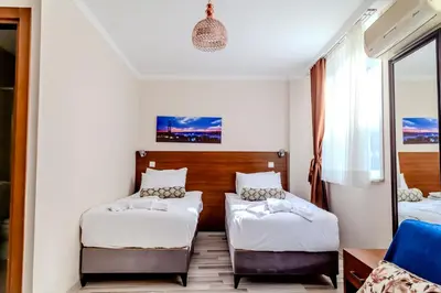 a bedroom with two beds and a window at City Hall Apart Hotel Sultanahmet in Istanbul