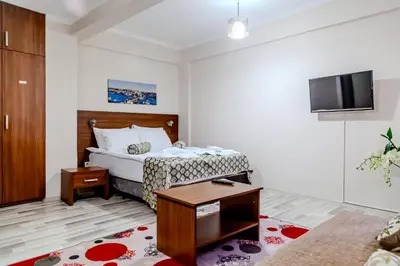 a hotel room with a bed and a tv at City Hall Apart Hotel Sultanahmet in Istanbul