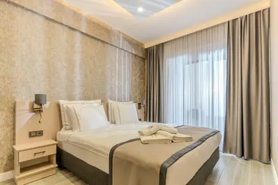 a bedroom with a large bed and a window at Olea Suites Otel in Gemlik