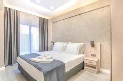 a hotel room with a bed with towels on it at Olea Suites Otel in Gemlik