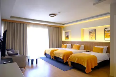 a hotel room with two beds and a window at Dugi Hotel in Istanbul