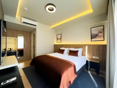 a hotel room with a bed and a television at Dugi Hotel in Istanbul