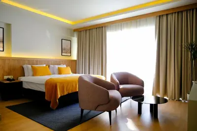 a hotel room with a bed and a chair at Dugi Hotel in Istanbul