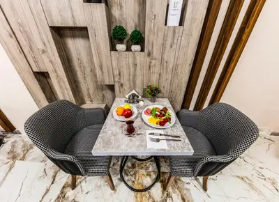 a table with two chairs and a plate of fruit at The Business Class Hotel in Istanbul