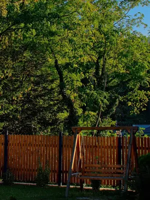 a wooden bench in front of a fence at Sapanca Grandwooden in Sakarya