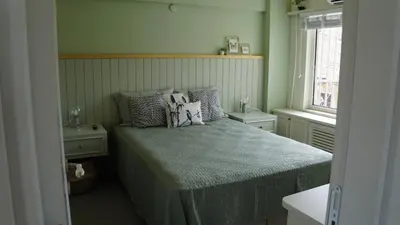 a bedroom with a bed with pillows and a window at Mood in Flats in Istanbul