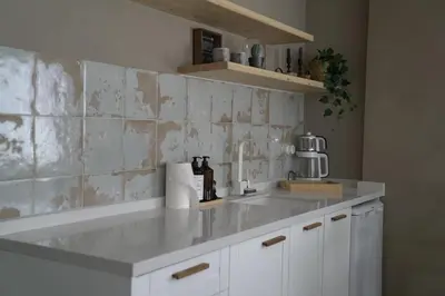 a kitchen with white cabinets and a counter top at Mood in Flats in Istanbul