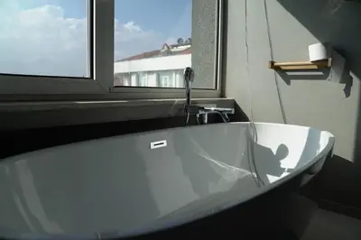 a white bath tub in a bathroom with a window at Mood in Flats in Istanbul