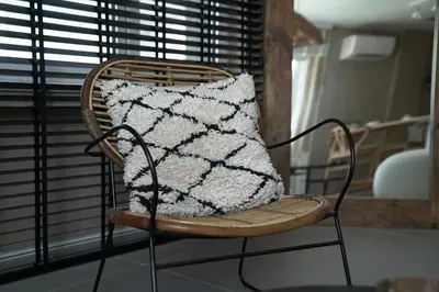 a chair with a pillow on it with a window at Mood in Flats in Istanbul