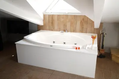 a white bath tub in a bathroom with a skylight at Destina Boutique Hotel Ağva in Sile