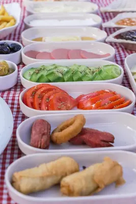a table topped with bowls of different types of food at Destina Boutique Hotel Ağva in Sile