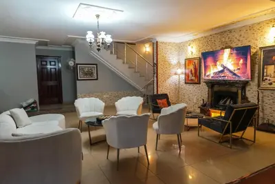 a living room with a table and chairs and a staircase at Destina Boutique Hotel Ağva in Sile