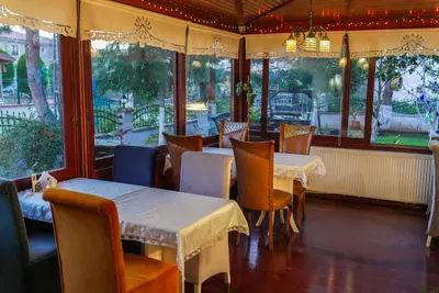 a dining room with tables and chairs and windows at Destina Boutique Hotel Ağva in Sile