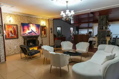 a living room with white chairs and a fireplace at Destina Boutique Hotel Ağva in Sile