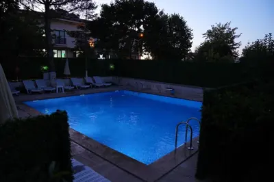 a large swimming pool with blue water in a yard at Destina Boutique Hotel Ağva in Sile