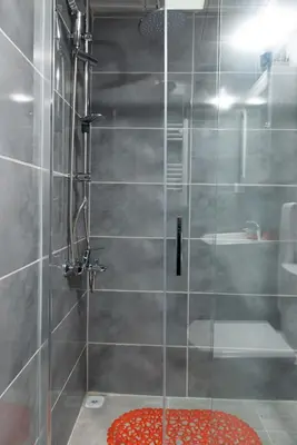 a bathroom with a shower with a glass door at G&B MANSION in Istanbul