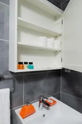 a white bathroom sink with an orange tool on it at G&B MANSION in Istanbul