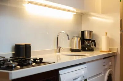 a kitchen counter with a stove and a sink at G&B MANSION in Istanbul
