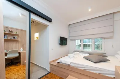 a bedroom with a large white bed and a desk at G&B MANSION in Istanbul