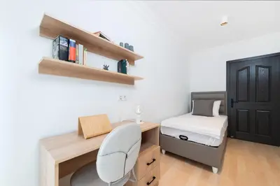 a bedroom with a desk and a bed and a chair at G&B MANSION in Istanbul