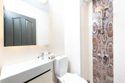 a bathroom with a toilet and a sink and a mirror at G&B MANSION in Istanbul
