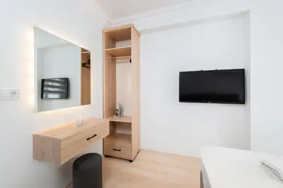 a bedroom with a bed and a tv on a wall at G&B MANSION in Istanbul