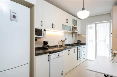 a kitchen with white cabinets and a sink at G&B MANSION in Istanbul