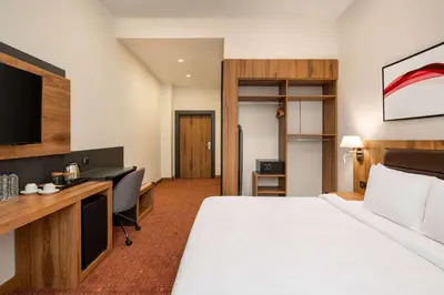 a hotel room with a bed and a desk at Ramada by Wyndham Karacabey in Bursa