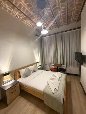 a bedroom with a large bed and a table at Taksim Millennium Alkan Residence in Istanbul