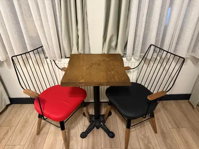 a wooden table with two chairs and a red chair at Taksim Millennium Alkan Residence in Istanbul
