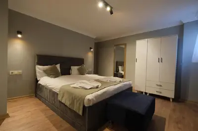 a bedroom with a large bed and a white cabinet at Berlin Hotel Nisantasi in Istanbul