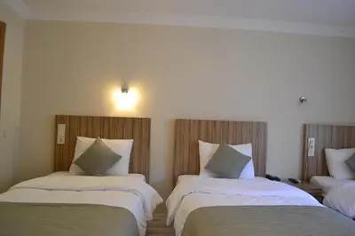 a hotel room with two beds with white sheets at Berlin Hotel Nisantasi in Istanbul