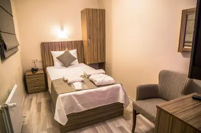 a bedroom with a bed with two towels on it at Berlin Hotel Nisantasi in Istanbul