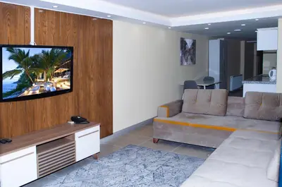 a living room with a couch and a flat screen tv at Berlin Hotel Nisantasi in Istanbul