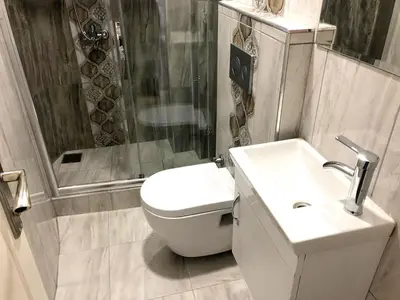 a bathroom with a toilet and a shower and a sink at Istanberry - Dream Apartments in Istanbul