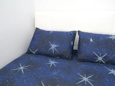 a bed with two pillows with stars on it at Istanberry - Dream Apartments in Istanbul