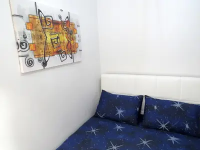 a room with a bed and a painting on the wall at Istanberry - Dream Apartments in Istanbul