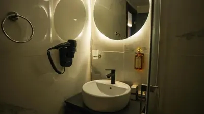 a bathroom with a sink and a mirror at Cip Hotel & Spa - İstanbul Bakırköy City Center in Istanbul