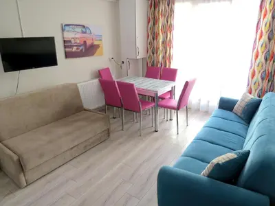 a living room with a couch and a table and chairs at Istanberry - Paradise Two Bedroom Apartments in Istanbul