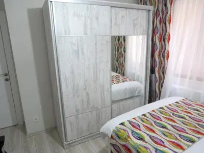 a large mirror in a bedroom with a bed at Istanberry - Paradise Two Bedroom Apartments in Istanbul