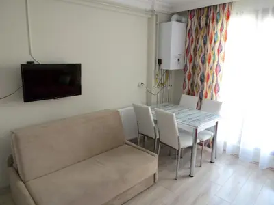 a living room with a table and chairs and a couch at Istanberry - Paradise Two Bedroom Apartments in Istanbul