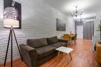 a living room with a couch and a brick wall at 5 Apartment Galata in Istanbul
