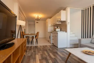 a kitchen and living room with a couch and a table at 5 Apartment Galata in Istanbul
