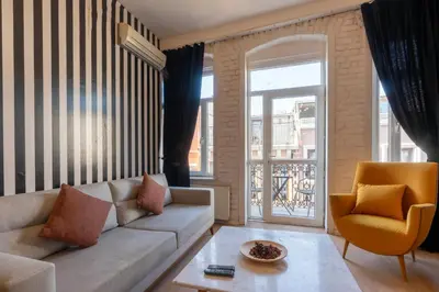 a living room with a couch and a chair at 5 Apartment Galata in Istanbul