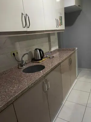 a kitchen with a sink and a counter top at Rosse Hotel in Esenyurt