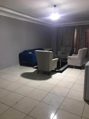 a living room with two chairs and a bed at Rosse Hotel in Esenyurt