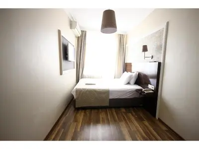 a small bedroom with a bed and a window at Venus Hotel Taksim in Istanbul
